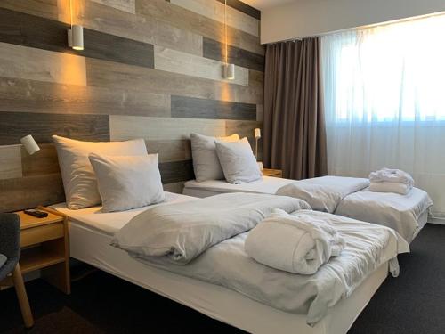 a hotel room with two beds with white pillows at Backcountry Hotel Sisimiut in Sisimiut