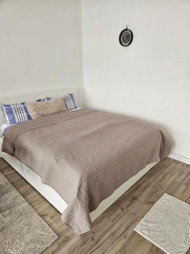 a bedroom with a bed with a clock on the wall at City Base Dortmund in Dortmund