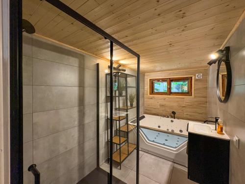 a bathroom with a tub and a sink at Willa Zielony Świat in Międzybrodzie Bialskie