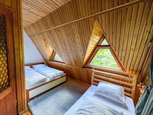 a room with two beds and a window at Willa Zielony Świat in Międzybrodzie Bialskie