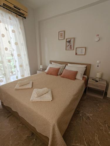 a bedroom with a large bed with two towels on it at Vivari apartment in Vivari