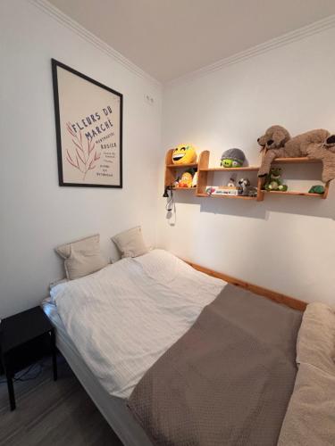 a bedroom with a bed and shelves on the wall at TanúHill Garden in Tapolca