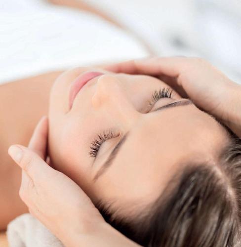 a woman getting her face washed at a spa at Kreuz-Post Hotel-Restaurant-SPA in Vogtsburg