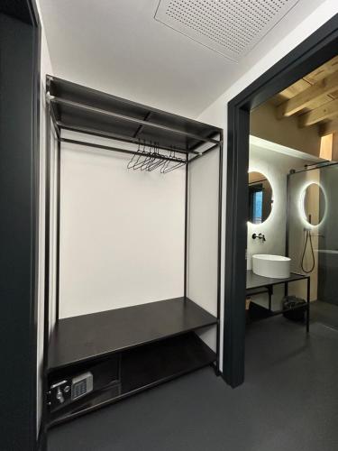 a bathroom with a large mirror and a sink at Camere Via Pasubio in Thiene