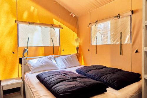 a bedroom with two large pillows on a bed at Glamping Sistiani in Lido di Spina