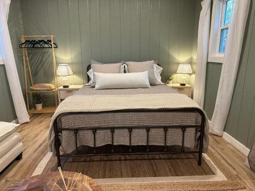 a bedroom with a bed with two tables and two lamps at 5 Oaks Casita in Abilene