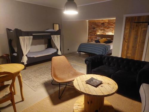 a living room with a couch and a bed at Nygården B&B Hälsingegård in Harmånger