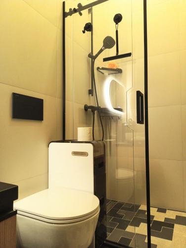 a bathroom with a toilet and a shower at SOL Apartment in Jūrmala