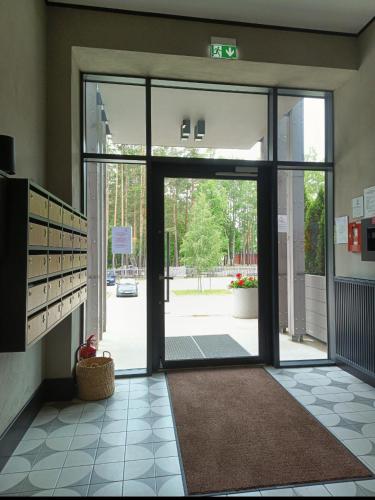 an entrance to a building with a large glass door at SOL Apartment in Jūrmala