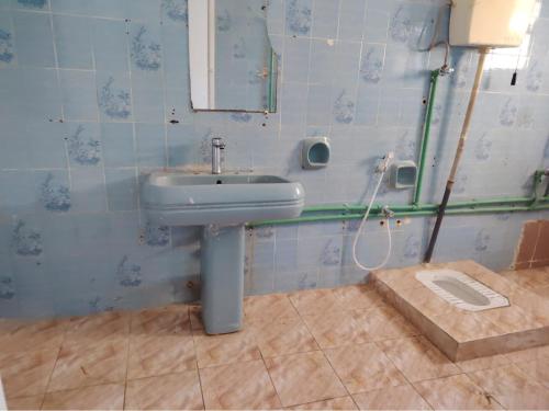a bathroom with a sink and a mirror at Turkish beach hostel in Muscat