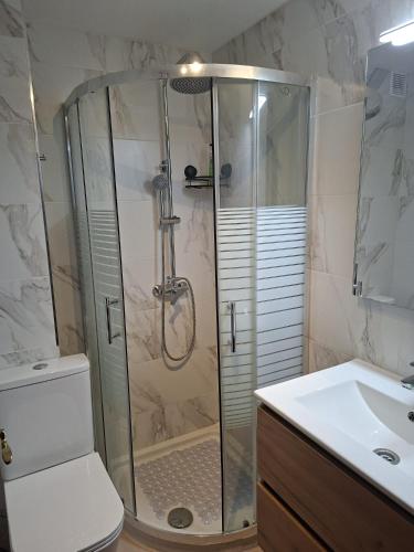 a bathroom with a shower and a toilet and a sink at Apartamento LOLO in El Médano