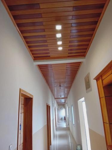 a hallway with a wooden ceiling in a building at Hôtel amsterdam in Douala