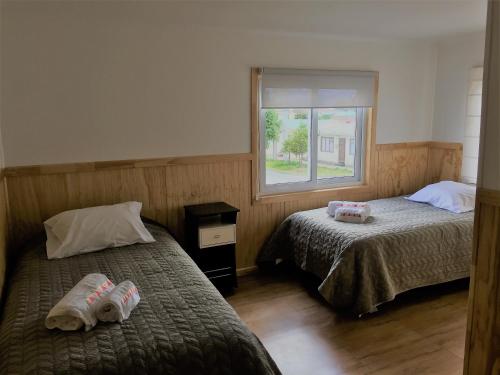 Ένα ή περισσότερα κρεβάτια σε δωμάτιο στο Hostal Andes Patagonicos