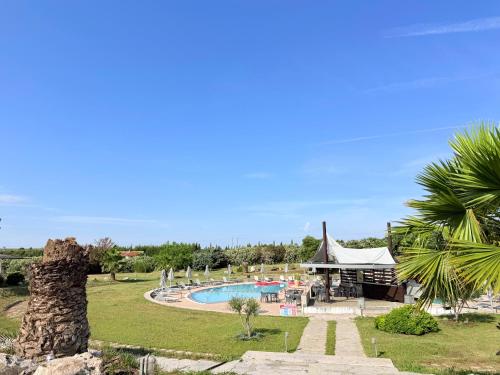 a resort with a swimming pool and a tent at Afremar Estate in Nea Fokea