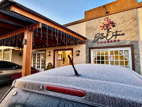 a car parked in front of a store with a car opener at Pousada Bello Outono in Canela
