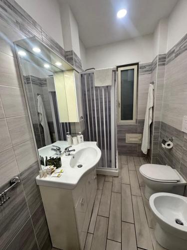 a bathroom with a sink and a toilet at Solforia Holiday House in Pozzuoli