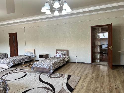 a living room with two beds and a rug at Apartmenthouse in Naryn