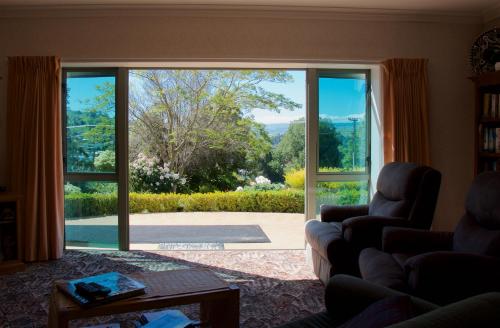 a living room with a large sliding glass door at Llanerchymedd in Taihape