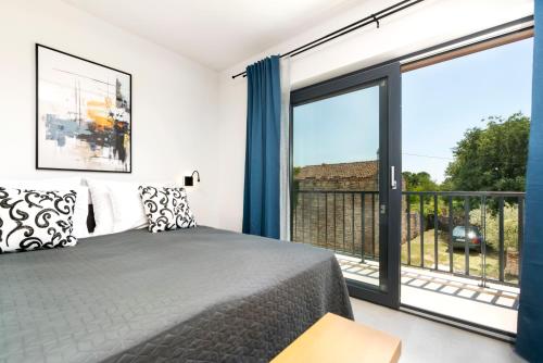 a bedroom with a bed and a large window at Ombra in Bale