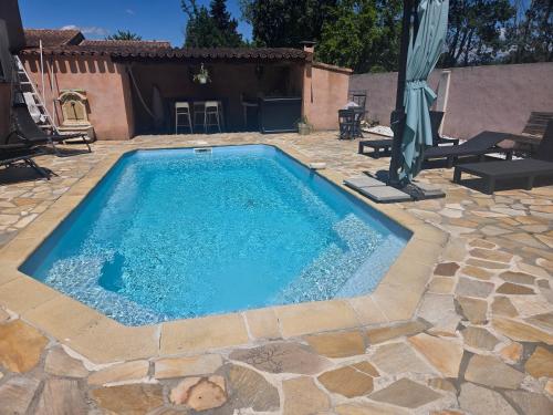 a swimming pool with a teddy bear sitting next to it at Tylyan in Le Thor