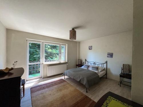 a bedroom with a bed and a large window at Willa Kotelnica in Międzybrodzie Bialskie