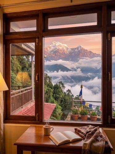 a window with a view of a mountain view at ANG'S Retreat By WINGS Expolores in Gangtok