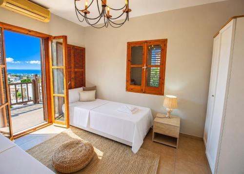 a bedroom with a white bed and a window at Casablanca Villa by HolidayKeys in Kyrenia