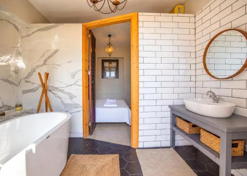a bathroom with a tub and a sink at Casablanca Villa by HolidayKeys in Kyrenia