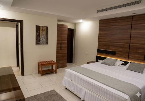 a bedroom with a large bed in a room at الا جنحة المخملية للشقق المخدومة - السلامة in Jeddah