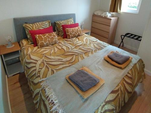 a bedroom with a bed with two pillows on it at OV815- Chalet Eveline in Blokzijl