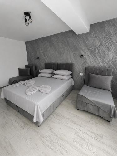a bedroom with a large bed and a chair at Ana L2 in Constanţa