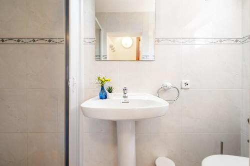 a white bathroom with a sink and a mirror at Can Freixa - Sóller in Sóller