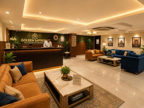 a lobby with couches and a bar in a hotel at Qotel Comfort Golden Saffron - Hotel in Punjabi Bagh Near Metro in New Delhi