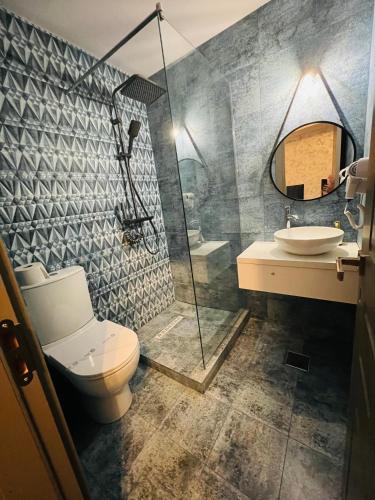 a bathroom with a shower and a toilet and a sink at Ana L2 in Constanţa