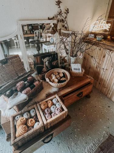 a table with several baskets of different types of donuts at Alpaca Bed & Fields in Snedsted