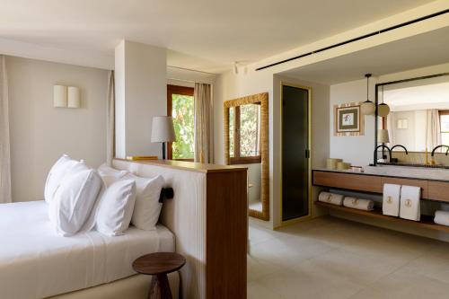 a bedroom with a bed and a large mirror at Gran Hotel Margalida by Annua Signature in Banyalbufar