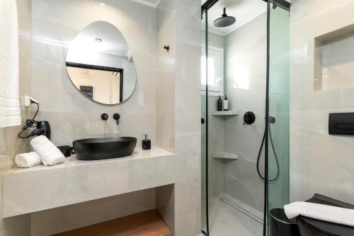 a bathroom with a sink and a shower at Elia village in Kalithies