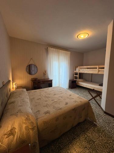 a bedroom with a bed and a bunk bed at Hotel Regina Yeti Bistrot in Sestola