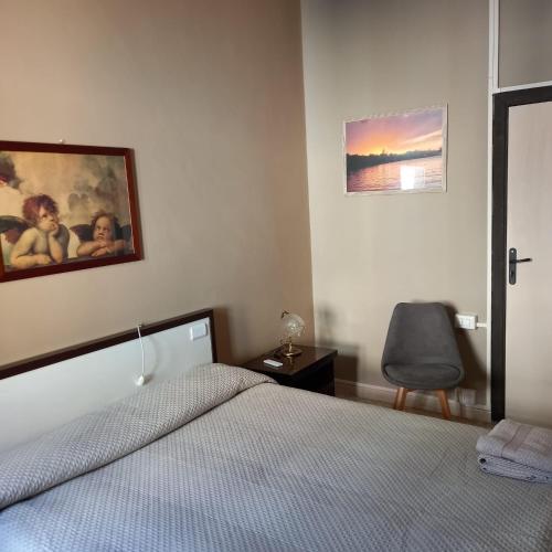 a bedroom with a bed and a desk and a chair at Casa Blu in Piediluco