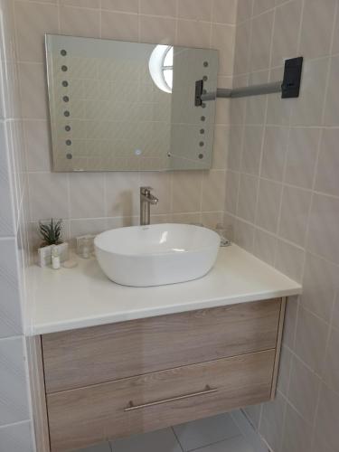 a bathroom with a white sink and a mirror at Galenia Boutique Hotel in Springbok
