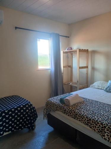 a bedroom with a bed and a window and a window at Casa pénareia in Amontada