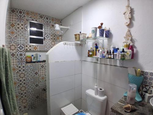 a bathroom with a shower and a toilet in it at Santa Monica Beach Tiny House in Guarapari