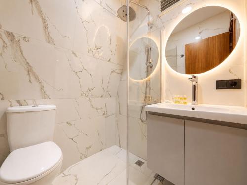 a bathroom with a toilet and a sink and a mirror at Gölbaşı Garden Villa in Uzungöl