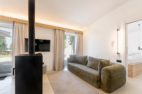a living room with a couch and a fireplace at TerraSena Mountain Village - Serra da Estrela in Seia