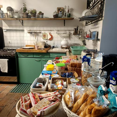 a kitchen with a table filled with lots of food at La Casa di Marla in Sirmione