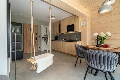 a kitchen with a swing in a house at Apartamenty Premium VIEW JACUZZI & SAUNA in Kościelisko