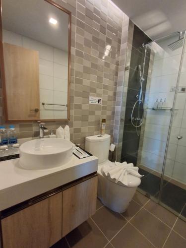 a bathroom with a sink and a toilet and a shower at Rawai Sea Escape 1BR With Rooftop Pool in Rawai Beach
