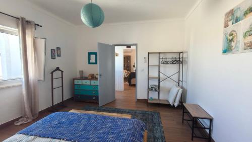 a bedroom with a bed and a room with a table at Alentejo Colours Cano in Cano