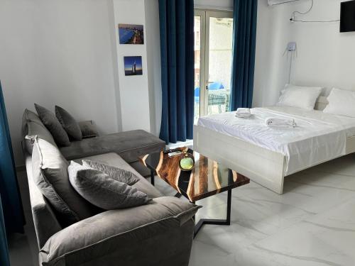 a living room with a bed and a couch at Radhima Sun Studio in Vlorë