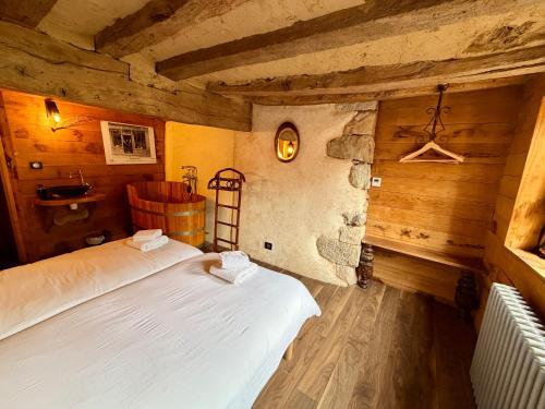 a bedroom with a bed in a room with wooden walls at Le Logis du Martray, maison historique in Lamballe Armor